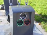 Public glass waste collection point in a neighborhood area for separating clear, green and amber glass