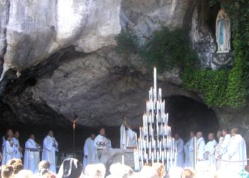 Mass celebrated at the Grotto at Lourdes. The chalice is displayed to the people immediately after the consecration of the wine.