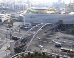 Multimodal traffic in Tel Aviv: pedestrians, private vehicles, buses, trucks and taxis (and accessible from the other side of the building shown is also a train station).