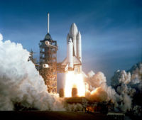 Columbia launching during STS-1. The original white-painted external tank, as well as Columbia's distinctive black chines, are clearly visible