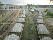 Freight wagons filled with limestone await unloading, at sidings in Rugby, England