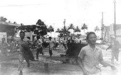 Hawai`i residents run from an approaching tsunami in Hilo, Hawai'i