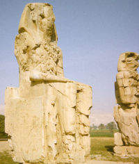 18 m (59 ft) high sandstone statues of Amenhotep III, flanking the entrance to his mortuary temple in Western Thebes - erroneously identified as the Colossi of Memnon by Greek travellers in antiquity