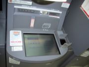 An ATM with a palm scanner (to the right of the screen)