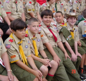 Boy Scouts having fun at a campfire ring at summer camp