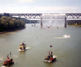 2001 Sourdough Raft Race, passing beneath the High Level Bridge's Great Divide waterfall during Klondike Days.