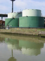 Oil tanks and a scrap metal yard line the Gowanus Canal.