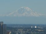 View of Mount Rainier from the observation deck of the Space Needle. Liberty Cap is the visible summit from this view, sitting atop the Willis Wall, the large snow-free area.