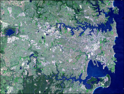 Image of Sydney taken by NASA RS satellite. The city centre is about a third of the way in on the south shore of the upper inlet. Click on the image and then scroll down for an annotated version.