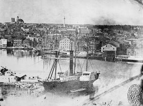 Baltimore harbor in 1849 with the prominent Washington monument in the background North of the city