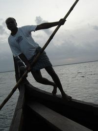 A boatman rows a traditional kettuvallam on Vembanad Lake.