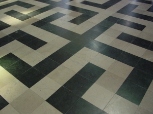 Interlocking swastika design in pavement of Amiens Cathedral.