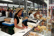 A cheese seller in a French market