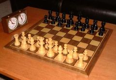 A typical Staunton-design chess set and clock.