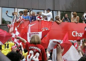 Arsenal's players and fans celebrate their 2004 League title win with an open-top bus parade