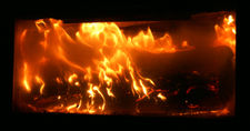 A log burning in a fireplace.