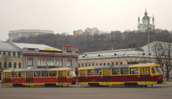 Trams in Kiev's Kontraktova Square. The St. Andrew Church is visible in the background