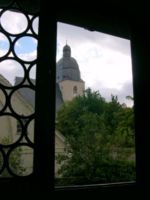 Looking out a window of the house where Luther was born to the church where he was baptized.