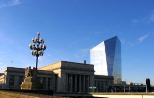 30th Street Station, with Cira Centre in the background and statues on the Market Street Bridge over Schuylkill River in the foreground.