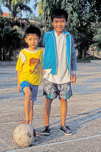 Children about to play football in Vietnam